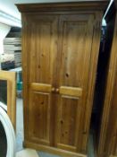 A pine two door wardrobe,