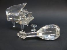 Two Swarovski Crystal musical instruments comprising a grand piano, 6cm long, and stool,