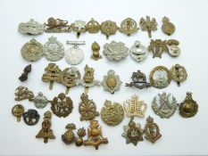 A WWII 1939-45 medal and a collection of military badges including Military Police, Army,