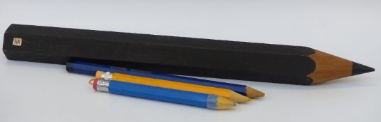 Four very large shop advertising pencils