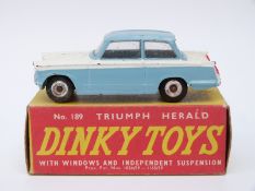 Dinky Toys diecast model Triumph Herald with blue and white body and spun hubs 189, in original box.