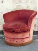 A red upholstered tub chair
