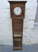An Art Deco style oak clock with cupboard to base,