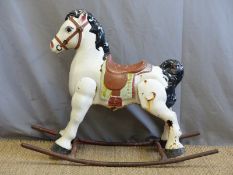 A vintage metal painted rocking horse.