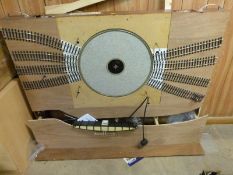 An 0 gauge model railway turntable on baseboard together with a coaling stage / water tower,