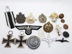 A collection of WWII memorabilia to include English and Nazi German badges including an Iron Cross,