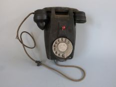 A vintage wall mounted telephone