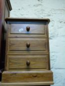 A pine bedside chest of three drawers W43 x D41 x H58cm
