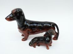 Beswick standing Dachshund together with a small seated example