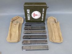 Six Sten gun magazines together with two British Army gun magazine pouches.
