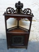 A 19thC corner cupboard with leaded glass door and pierced top,
