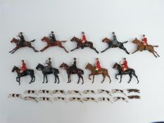 Twenty-three Britains lead model hunting figures and animals comprising five galloping huntsmen and