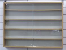 A wooden train or model display cabinet with sliding glass doors and removable shelves,