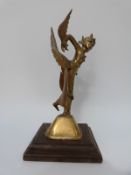 A pair of Indonesian or Thai brass figures of winged deities mounted on wood plinth bases,