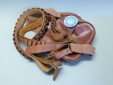 A leather cartridge/ shooting bag together with two leather cartridge belts one .