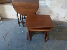 An oak drop leaf table and a nest of tables
