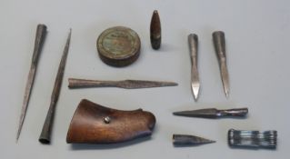 A pair of Smith & Wesson wooden revolver grips together with seven metal crossbow bolt tips,