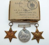A group of three WWII medals in original box awarded to E S Levett,