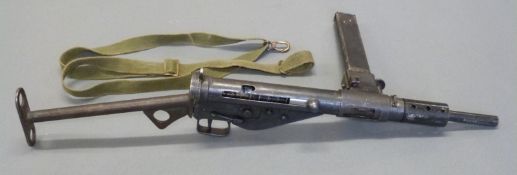 Deactivated 9mm Sten Mk2 submachine gun with magazine, canvas sling,
