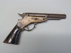 American 7mm centre fire pistol with brass frame, shaped wooden grips, cone shaped foresight,
