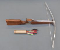 An English wooden framed crossbow with adjustable rear sight and shaped stock,