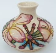 Moorcroft vase of squat form with decoration of pink flowers on a cream ground, 10cm tall,