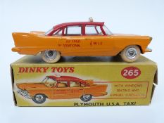 Dinky Toys diecast model Plymouth USA Taxi with yellow and red body, cream interior,