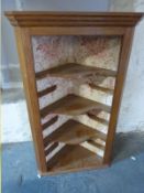 An open fronted corner cupboard,