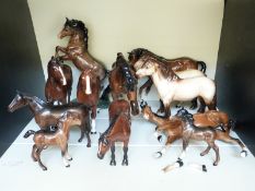 Twelve various Beswick horses including two Highland
