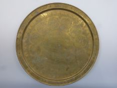 A brass tray with Islamic decoration,