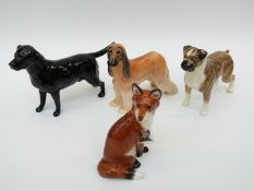 Three Beswick dogs comprising Afghan Hound, Black Labrador and Boxer,