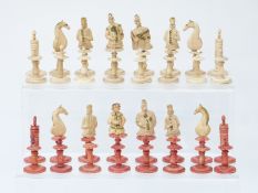 An 18thC German carved bone figural chess set with natural and stained red pieces,