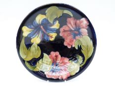 Moorcroft bowl in Hibiscus pattern on a blue ground, signed to base,