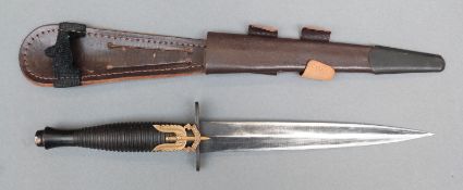 A Fairbairn Sykes style fighting knife in scabbard with SAS motif,