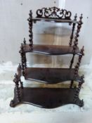 A barley twist whatnot with pierced frieze to top,