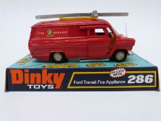 Dinky Toys diecast model Ford Transit Fire Appliance with red body, yellow interior,