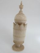 An Indian ivory chess piece with a turned pedestal base, bulbous top and finial, 12.5cm tall.