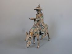 A Tang style cast metal model of a man on a donkey