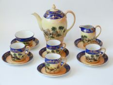 A Czechoslovakian Art Deco porcelain part coffee set decorated with desert scenes in the Noritake