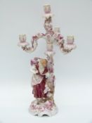 A German figural three branch porcelain candelabra,