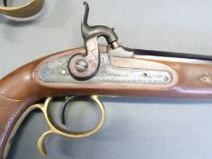 A pair of percussion hammer action pistols with chequered grip, ornate engraving to the locks,