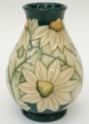Moorcroft vase decorated with flowers on a green ground,