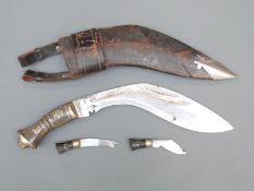 Kukri knife with lions head to hilt, decorated blade,