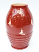 A Clarice Cliff vase decorated with boats on a red ground,