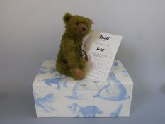 Steiff Teddy Bear Jules with moss green mohair, wood and feather pendant and jointed limbs,
