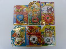 Six early hand-held 1st generation Tamagotchi style computer games/ pets, all in original packaging.
