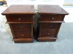 A pair of bedside chests of three drawers,