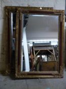 A pair of gilt framed mirrors with bevelled edge,
