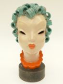 A pottery female bust on wooden plinth, probably Goldscheider,