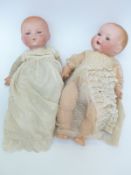Two Armand Marseille bisque headed dolls one with open mouth, weighted brown eyes,